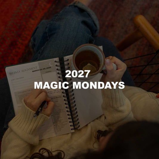 A woman writing in her Dreambook's Weekly Alignment pages with a cup of tea, with the text 2027 Magic Mondays