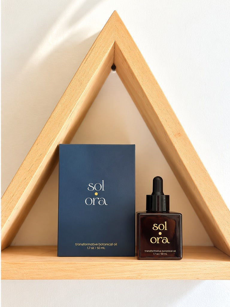 The Sol Ora carton and bottle framed by a wooden triangle shelf