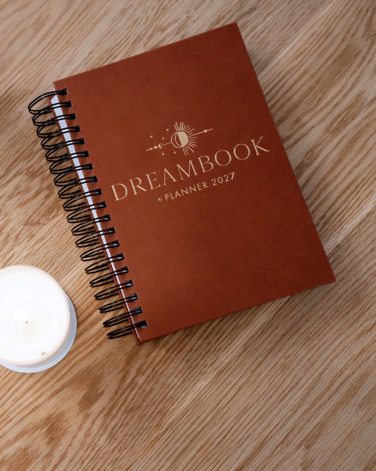 The Saddle 2027 Dreambook + Planner beside a cup of coffee