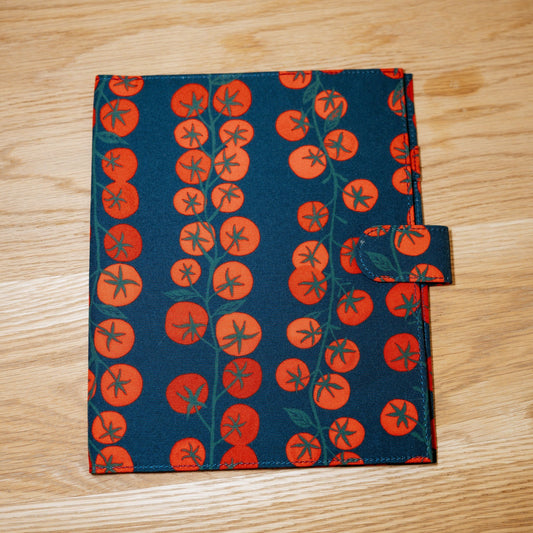 The Heirloom cover: navy printed with vines of bright red tomatoes