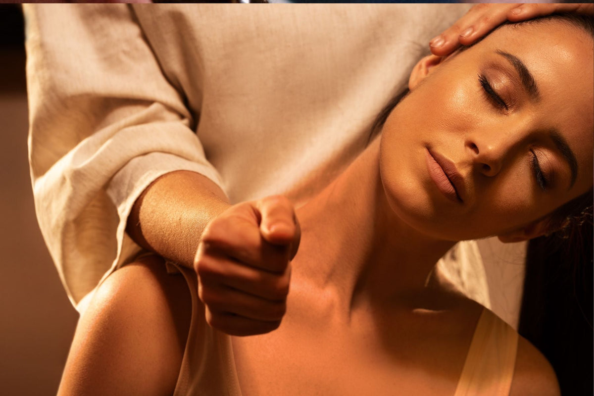 A therapist massaging a guest's neck and shoulders