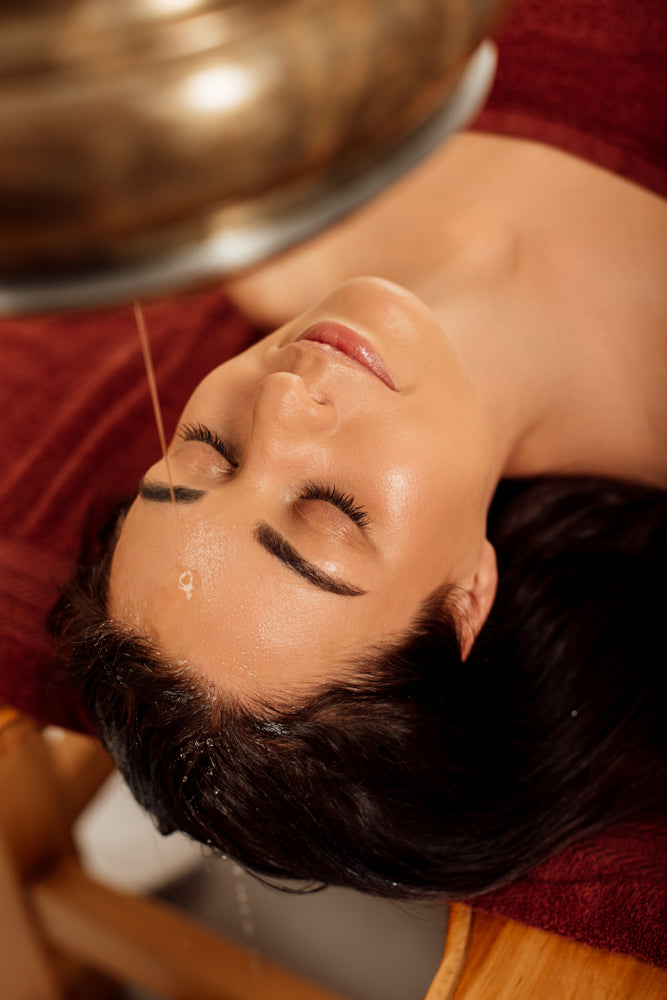 Warm oil flowing over the forehead during shirodhara