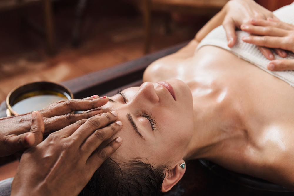 A guest receiving an Ayurvedic treatment