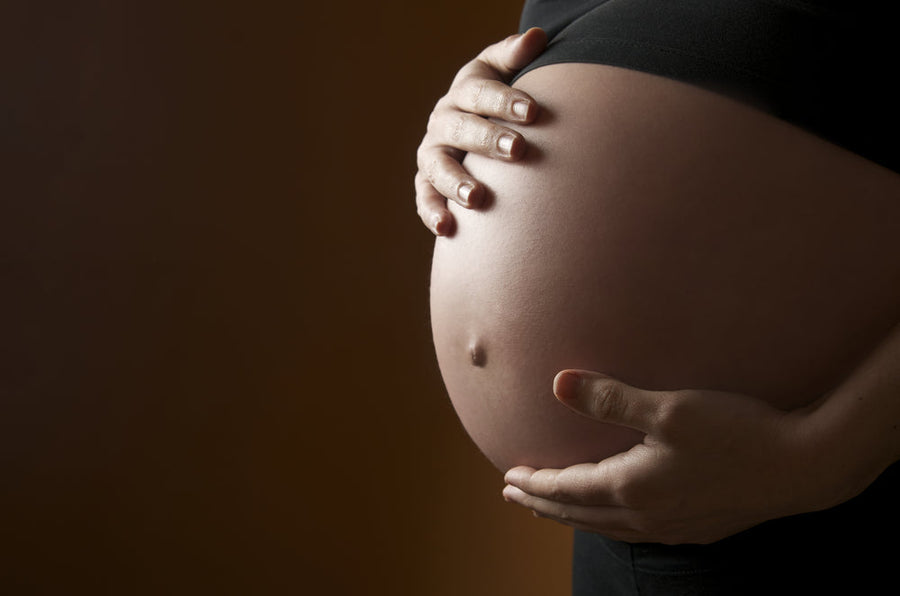A pregnant guest resting comfortably during a prenatal massage